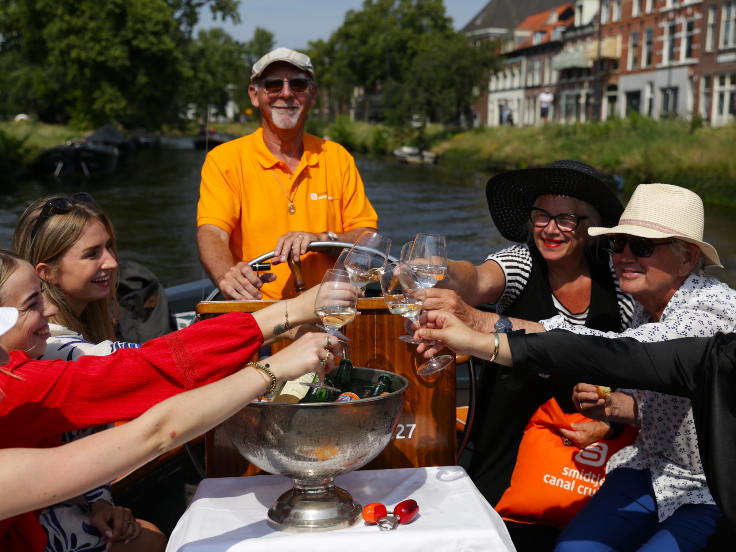 a group of people are drinking from a river